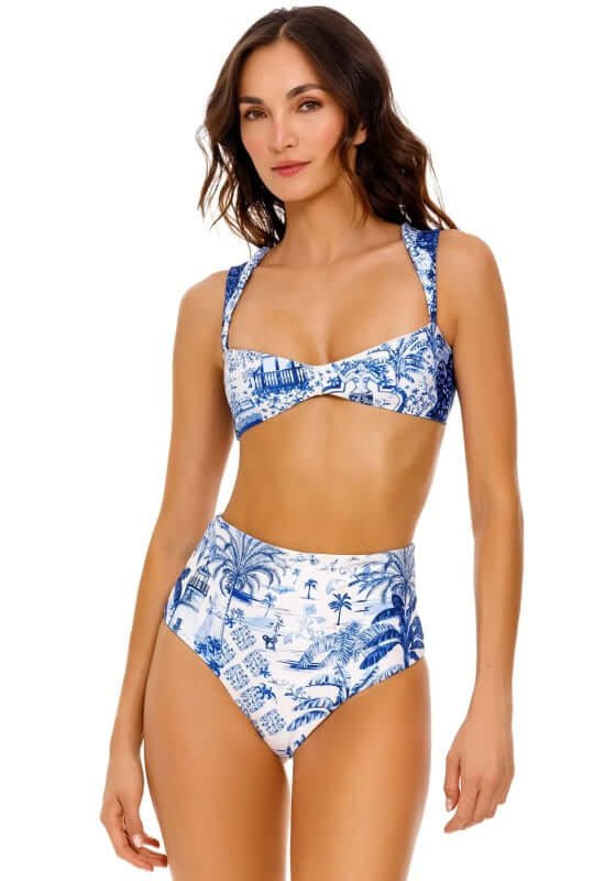 Malory Bikini Top Tales by Agua Bendita, featuring a stunning blue and white patterned bikini top on a model.