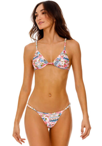 Belle Bikini Meraki by Agua Bendita featuring vibrant floral patchwork and adjustable straps on a model.