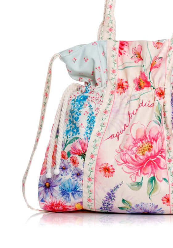 Sonja Bag Chroma by Agua Bendita features floral prints, a drawstring closure, and handmade strap details.
