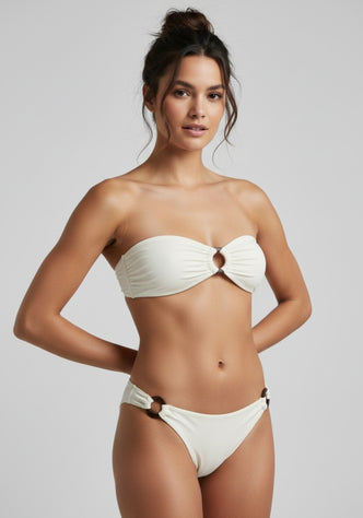 Kate Bandeau Bikini Sand by Alicia Swim model wearing a stylish bandeau bikini with coconut ring details.