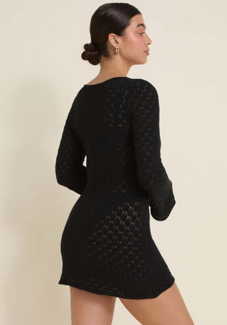 Havana Dress Black by Away That Day, showcasing the elegant bell sleeves and figure-hugging knit design.