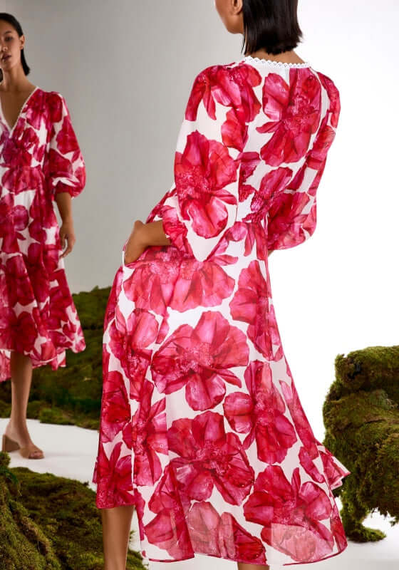 Fata Long Dress White Blossom by Charo Ruiz, featuring a vibrant pink floral print and elegant flounced skirt.