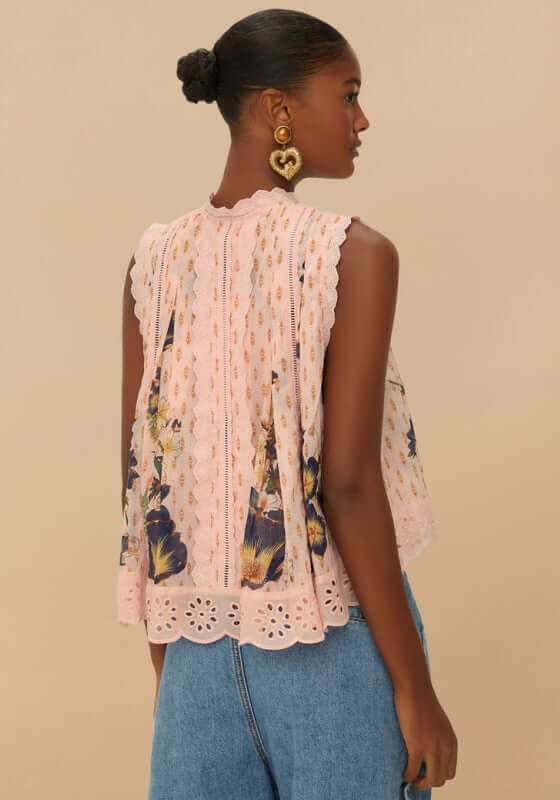 Pink Dream Garden Blouse by Farm Rio, showcasing a woman in a pastel blouse with floral patterns and ruffles from the back.
