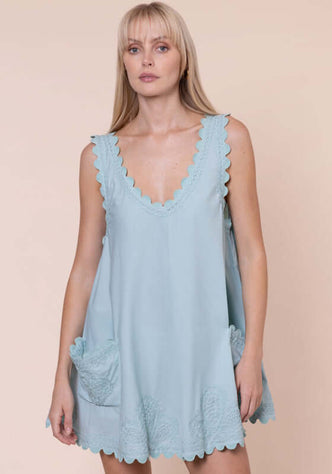 Ric Rac Low Back Dress Pistachio by Juliet Dunn, featuring a light blue mini dress with scalloped edges and patch pockets.