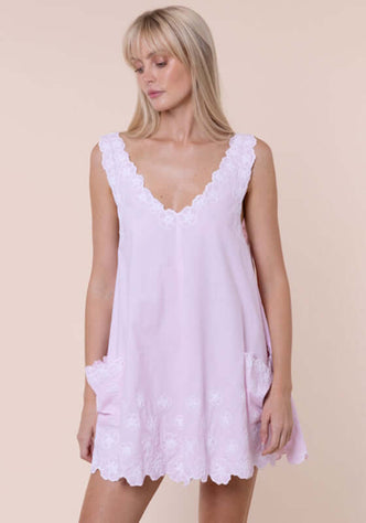 Poplin Floral Low Back Dress Petal Pink by Juliet Dunn, showcasing a light pink dress with lace trim and patch pockets.