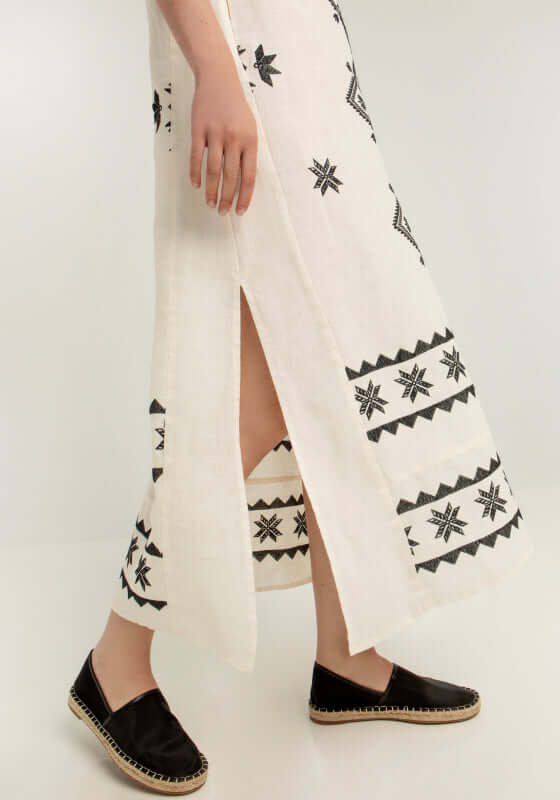 Lefkada Belted Midi Dress Natural by Greek Archaic Kori featuring black embroidery and side slit detail.