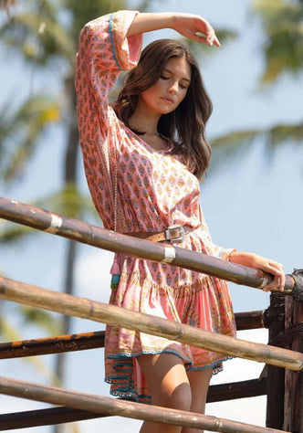 Kaida Dress by Miss June, a model showcasing a romantic puffed sleeve dress with ruffles and floral patterns.