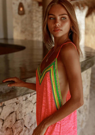 Inca Slip Dress Hot Pink by Pitusa, model showcasing elegant beachwear with embroidered trim and side slits.