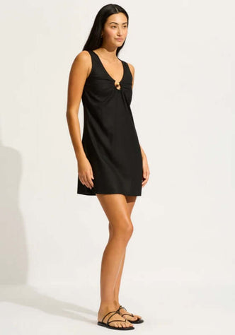 Palermo Keyhole Mini Dress Black by Seafolly, featuring a V neckline and tie-back design, shown on a model.