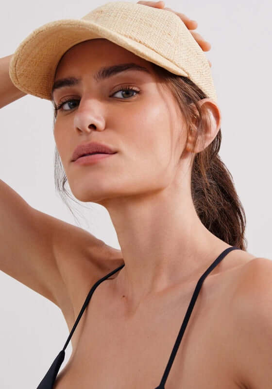 Jane Cap by Vix worn by model, showcasing stylish straw design and adjustable strap.