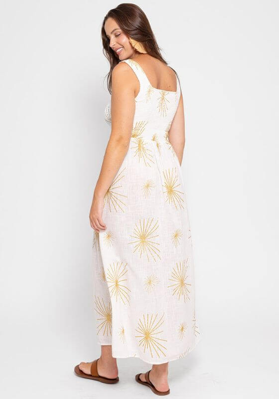 Amande Sevilla Dress by Sundress, a white maxi dress with golden suns, featuring a square neck and thick straps.