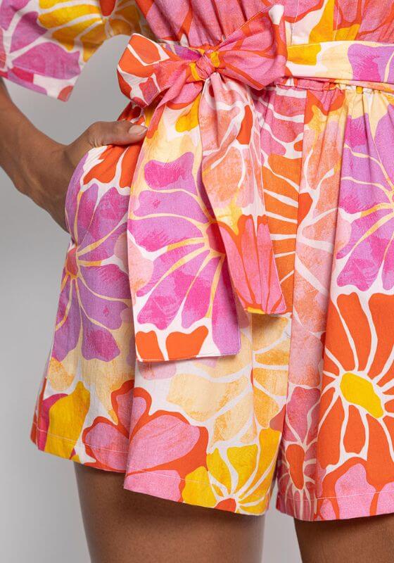 Audrey Jumpsuit Saleya by Sundress featuring vibrant floral prints and a belted waist for a stylish beach look.