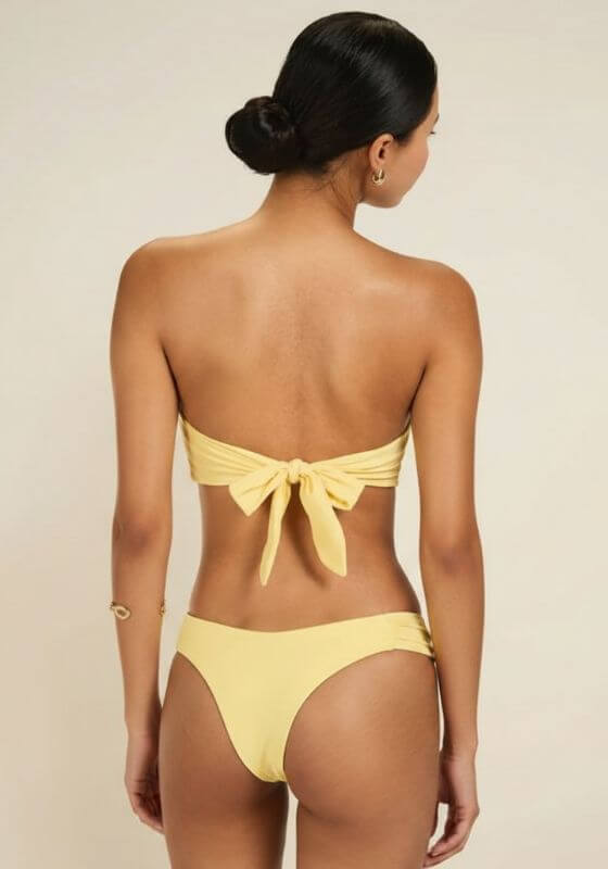 Buttercup Cayman Island Bikini by Away That Day, showing the back view with bandeau top and ruched side bottoms.