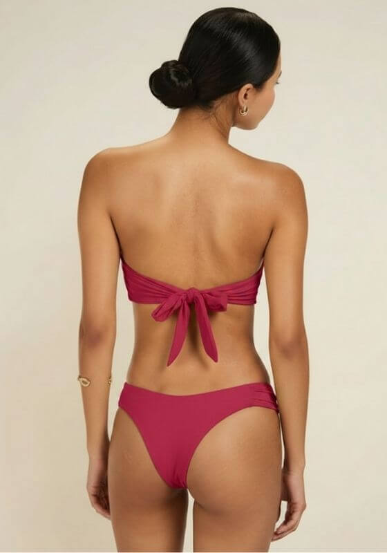Raspberry Cayman Island Bikini by Away That Day shown from the back, featuring a bandeau top and ruched side bottoms.