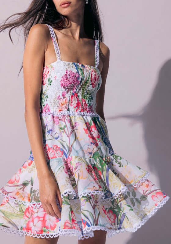 Iris Short Dress White Botanical by Charo Ruiz featuring a flirty layered skirt and smocked bodice with floral design.