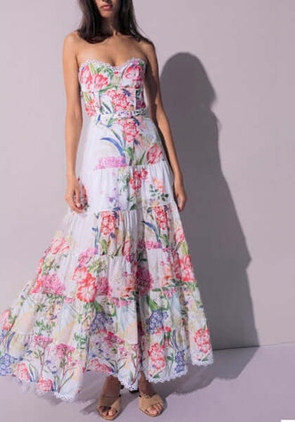 Danny Long Dress White Botanical by Charo Ruiz showcasing a fitted bodice and elegant floral print on a flowing maxi silhouette.