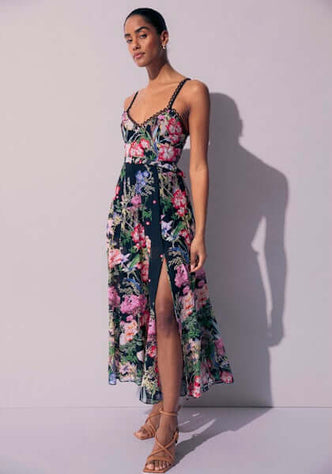 Iraso Long Dress Black Botanical by Charo Ruiz, featuring floral prints and a thigh-high slit.