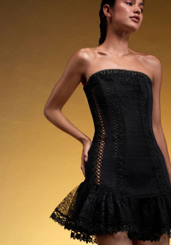 Victoire Dress Black by Charo Ruiz. Strapless dress featuring delicate guipure and ruffled lace detail.