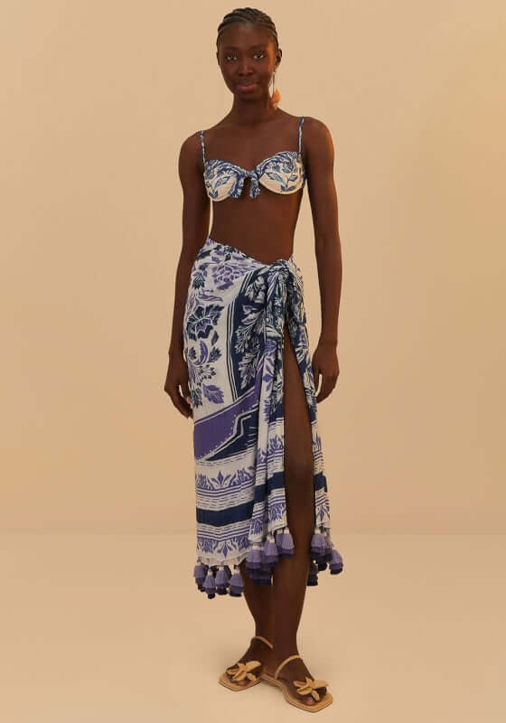 Delicate Tapestry Sarong by Farm Rio, featuring a model wearing a stylish blue sarong with tassels.