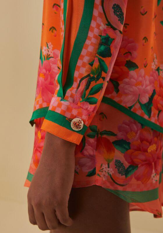 Fruit Garden Scarf Shirt by Farm Rio, showing a vibrant orange floral print and a cuffed sleeve detail.