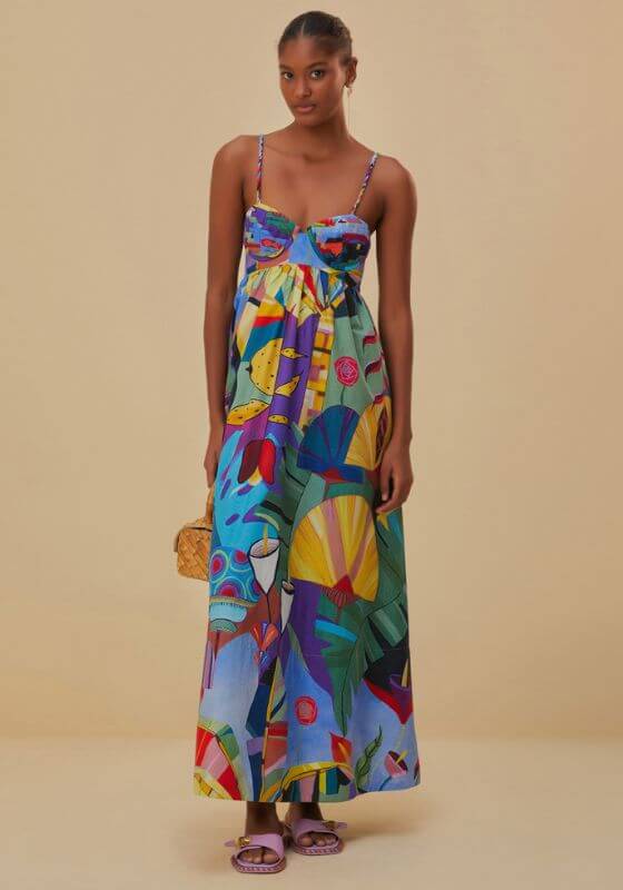 Tropical Scenario Maxi Dress by Farm Rio, model wearing a colorful sleeveless maxi dress with spaghetti straps and a flowy skirt.