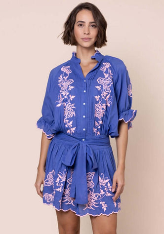 Butterfly Blouson Dress Denim by Juliet Dunn, featuring blue fabric with pink butterfly embroidery, puff sleeves, and a bow detail.