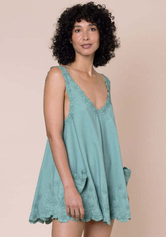 Poplin Floral Low Back Dress Cactus by Juliet Dunn, showcasing a model in a light teal dress with a low back and lace trim.