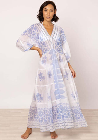 Dhaka V Neck Kaftan Blue by Juliet Dunn, showcasing a relaxed silhouette and tiered hemline in blue and white.