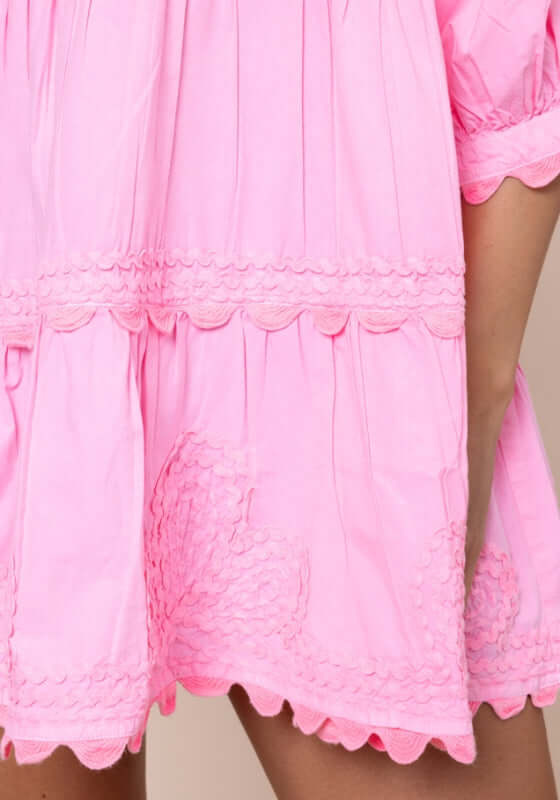 Poplin Tiered Mini Dress Flamingo by Juliet Dunn, showcasing vibrant pink fabric with scalloped hem details.