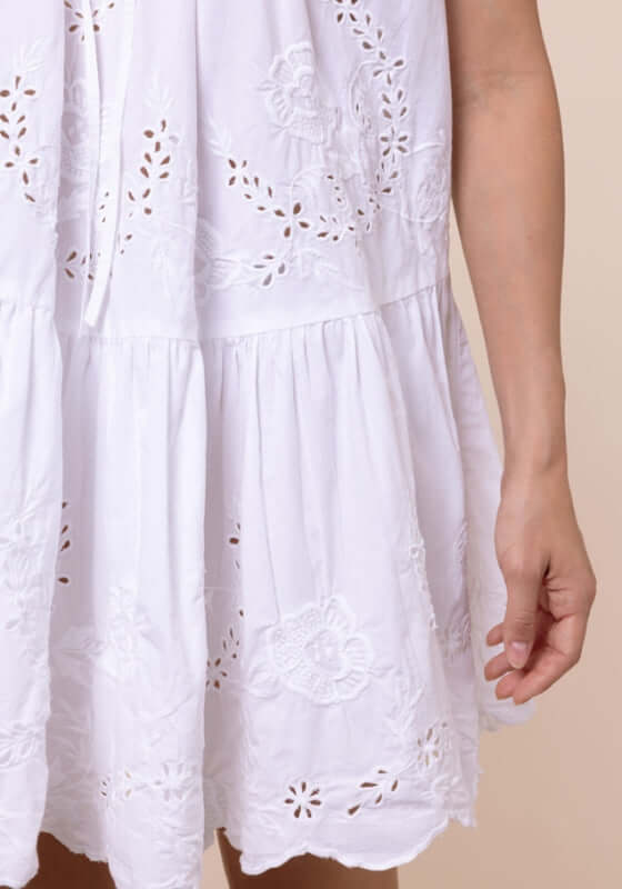 Floral Embroidery Strappy Mini Dress by Juliet Dunn showcasing intricate floral embroidery on a white cotton fabric.