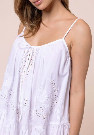 Floral Embroidery Strappy Mini Dress by Juliet Dunn, showcasing light white fabric with intricate floral embroidery and strappy design.