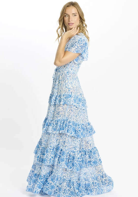 Celia Dress Blue by Miss June, showcasing a tiered maxi design in blue and white, featuring a V-neckline and short sleeves.