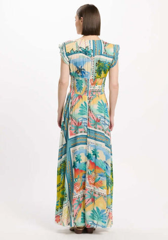 Taly Dress by Miss June, showcasing a vibrant postcard-style print with palm trees on soft blue fabric from the back.