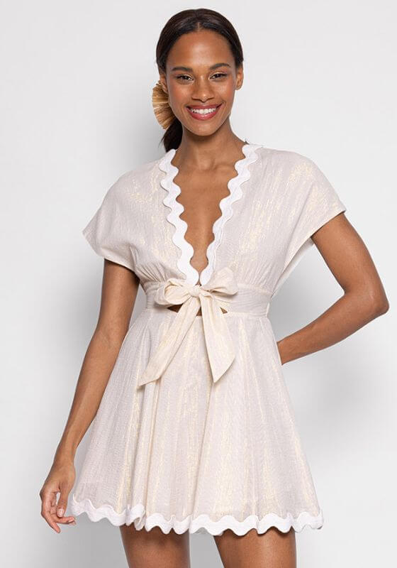 Nora Short Tenerife White by Sundress, elegant short white and gold dress with V neckline and bow detail.