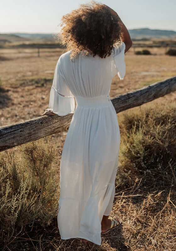Barbados Dress White by Piti Cuiti, featuring a V-neckline and floaty peplum sleeves, perfect for summer breezes.