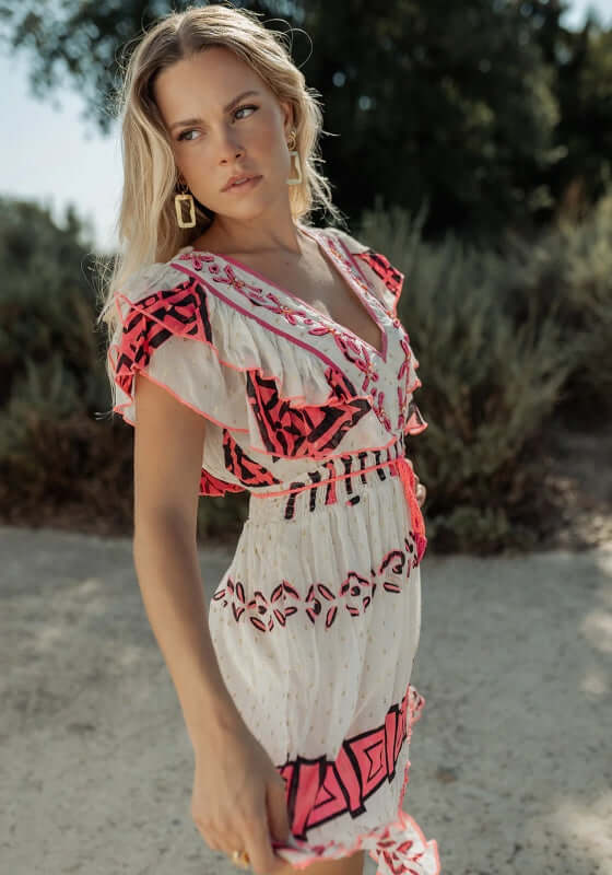 Sidi Kaouki Short Dress by Piti Cuiti, model featuring vibrant neon pink embroidery and tassel drawstring waist.