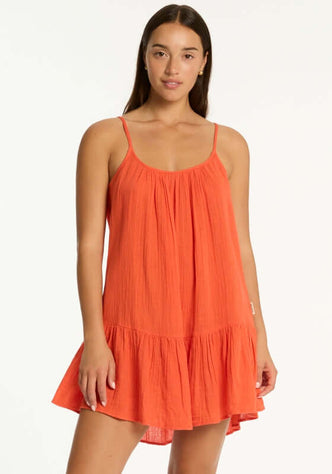 Sunset Short Beach Dress Flame by Sea Level, a model wearing a red flame beach dress in a breezy silhouette.
