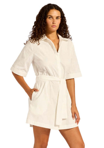 Mini Shirt Dress White by Seafolly, showcasing a model in a white mini shirt dress with short sleeves and an adjustable waist tie.