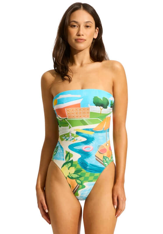 Sunset DD Bandeau Swimsuit by Seafolly, displayed on a model, featuring a colorful poolside design and strapless style.