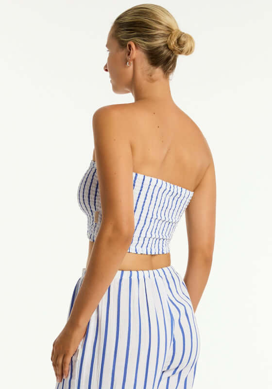 Amalfi Beach Bandeau Top Blue by Sea Level, model wearing blue and white striped bandeau top from the back.