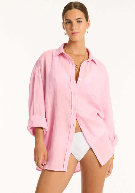 Sunset Beach Shirt Pink by Sea Level, featuring a model wearing a baby pink oversized shirt with rolled sleeves.