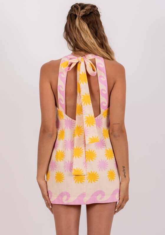 Felipa Mini Dress Praia Print by Sundress, showcasing the back with a large knot detail and vibrant print.