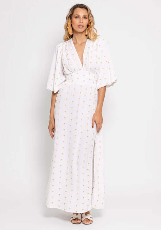 Aurelie Dress Gold Palm Trees by Sundress, model wearing white lightweight maxi dress with gold palm tree embroidery.