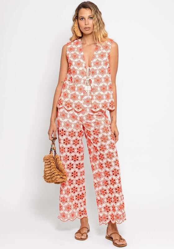 Lupy Pant Eyelet Red by Sundress, model wearing a stylish red floral ensemble with spaghetti straps against a white background.