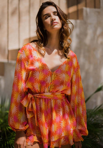 Fleur Jumpsuit Marbella Yuma by Sundress in vibrant floral print with adjustable waist and V neckline.