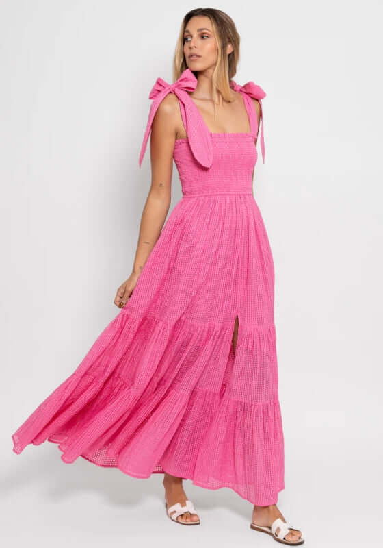 Jade Dress Gingham Pink by Sundress, a pink gingham maxi dress with wide shoulder ties and a thigh-high slit.