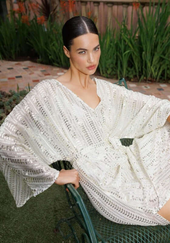 Leandra Dress Bora Bora by Sundress, featuring a sequin pattern v-neckline and wide floaty sleeves on a model.
