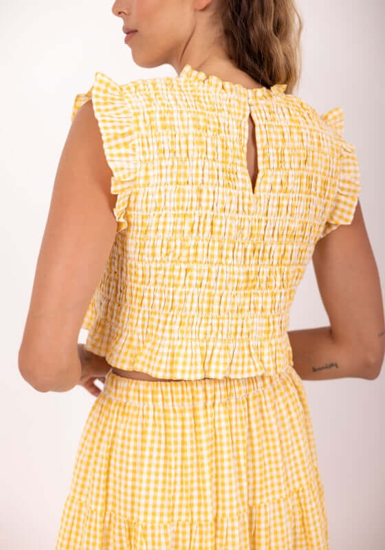 Malone Top Yellow Gingham by Sundress, showcasing ruched tiers and ruffle cap sleeves from the back.