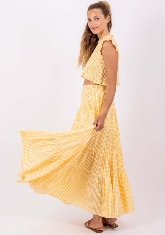 Odette Skirt Yellow Gingham by Sundress, model in yellow gingham tiered maxi skirt, styled with matching top.