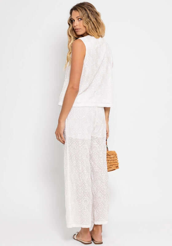 Bao Top Santorini White by Sundress, model wearing an elegant white embroidered top with matching pants from behind.